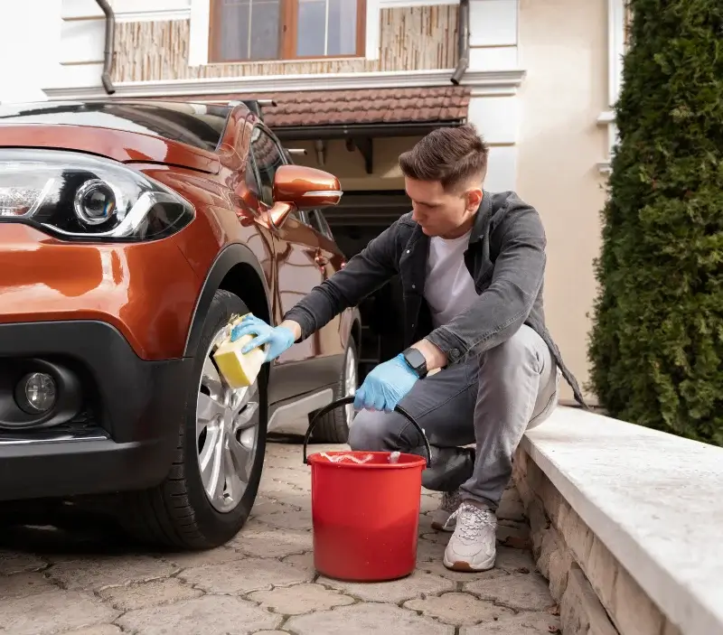 Lavage auto à domicile Saint-Pierre-du-Mont : professionnel intervenant sur un véhicule